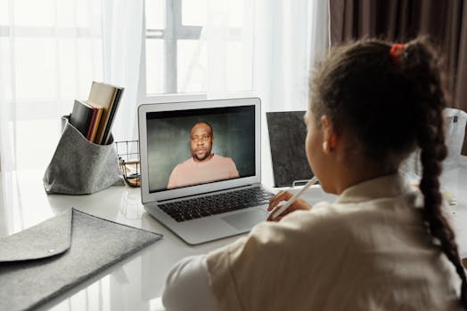 Child attending an online lesson at home via laptop. Remote education.