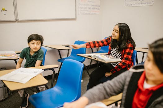 Students in a classroom, with one pointing and others studying, representing a school scene.
